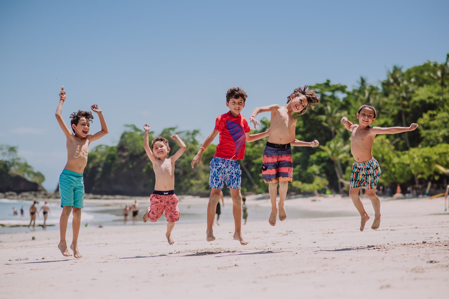 Kids jumping on the beach